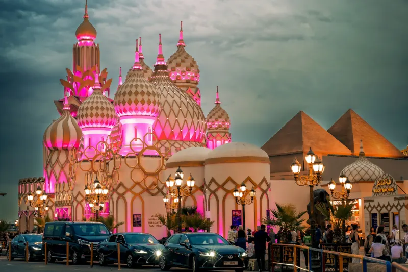 Illuminated pavilions at Global Village Dubai at dusk