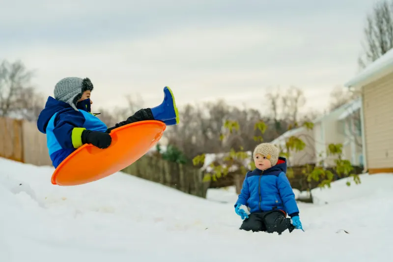 Children sledding and playing in the snow