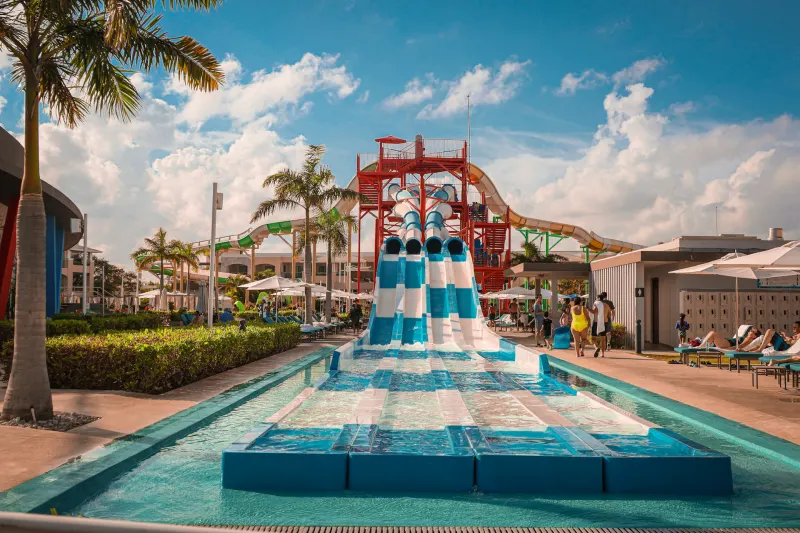 Water slides and pools at a waterpark with palm trees