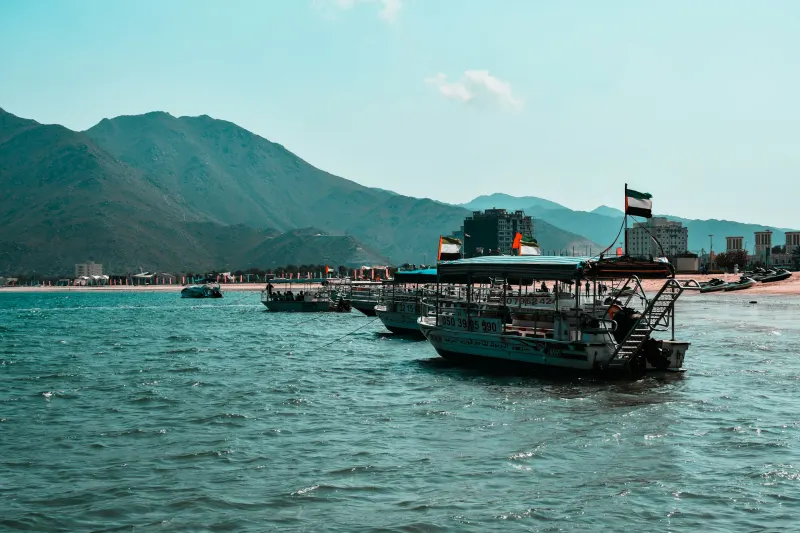 Boats in the bay at Khor Fakkan with the Hajar Mountains on the UAE east coast