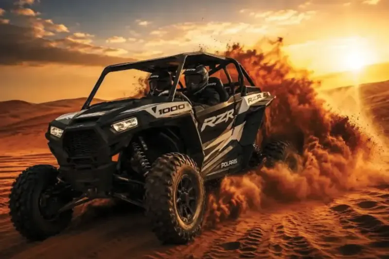 2 seater dune buggy driving through the red dunes at sunset on a Dubai desert safari