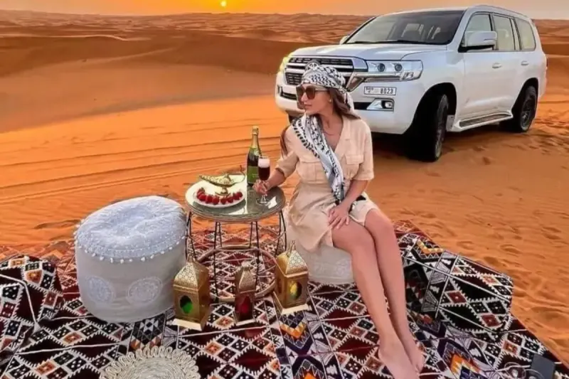 VIP desert setup with lanterns and a Land Cruiser at sunset on a VIP desert safari in Dubai